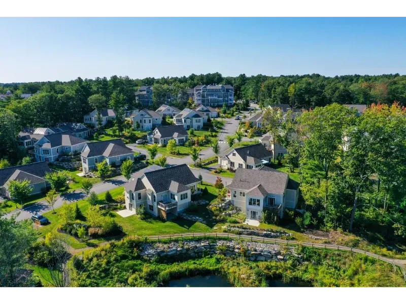An aerial view of a residential area with lots of houses and trees