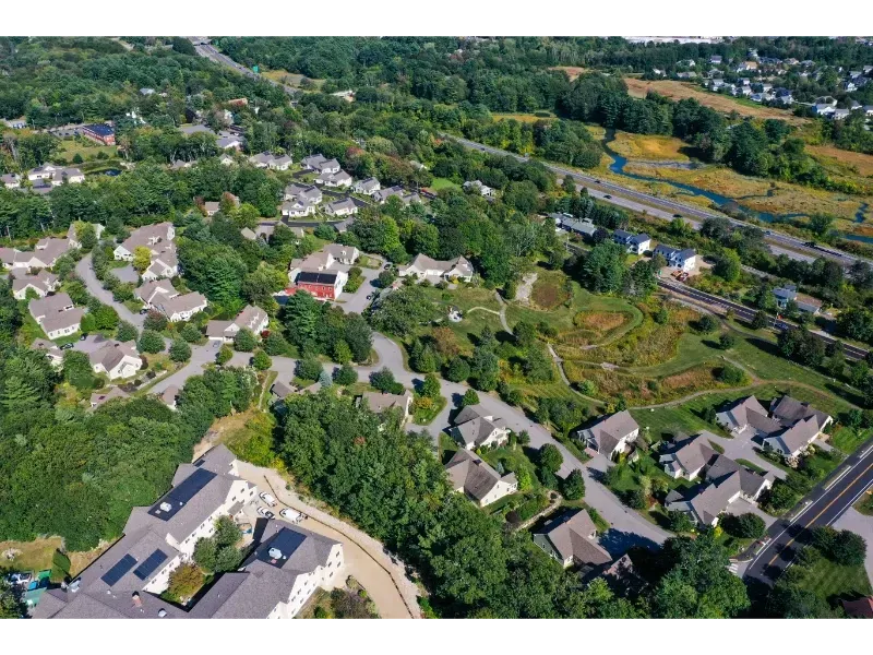 An aerial view of a residential area with houses and trees