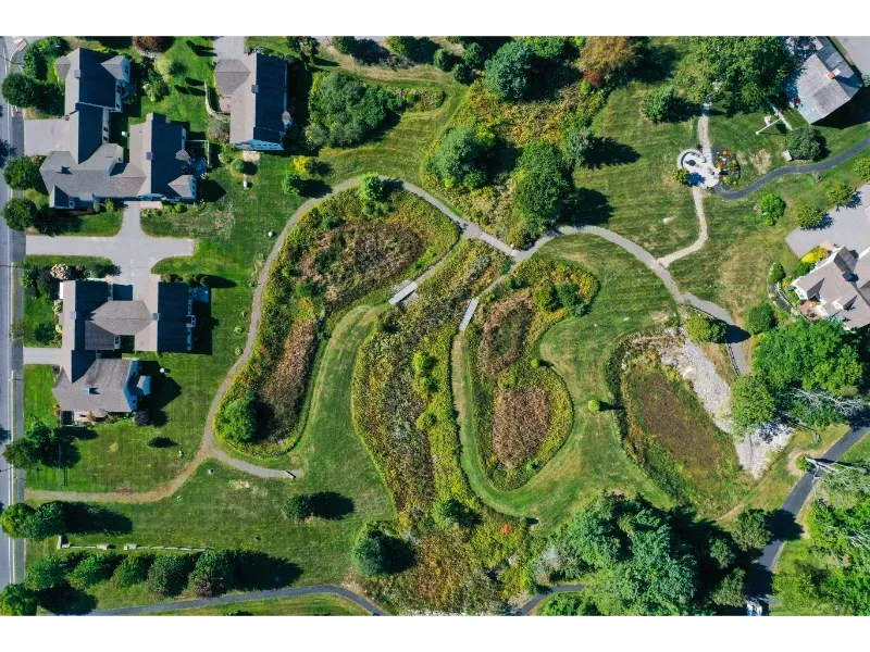 An aerial view of a residential area with houses and trees