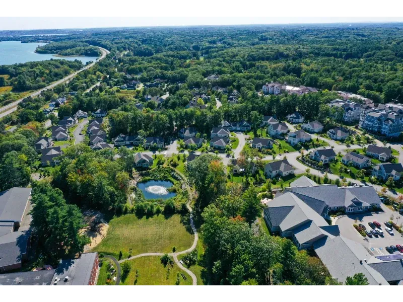 An aerial view of a residential area with a lake in the background