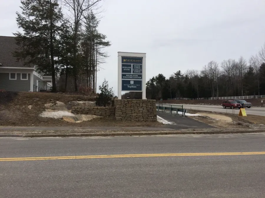 A sign on the side of a road that says ' abercrombie & fitch ' on it