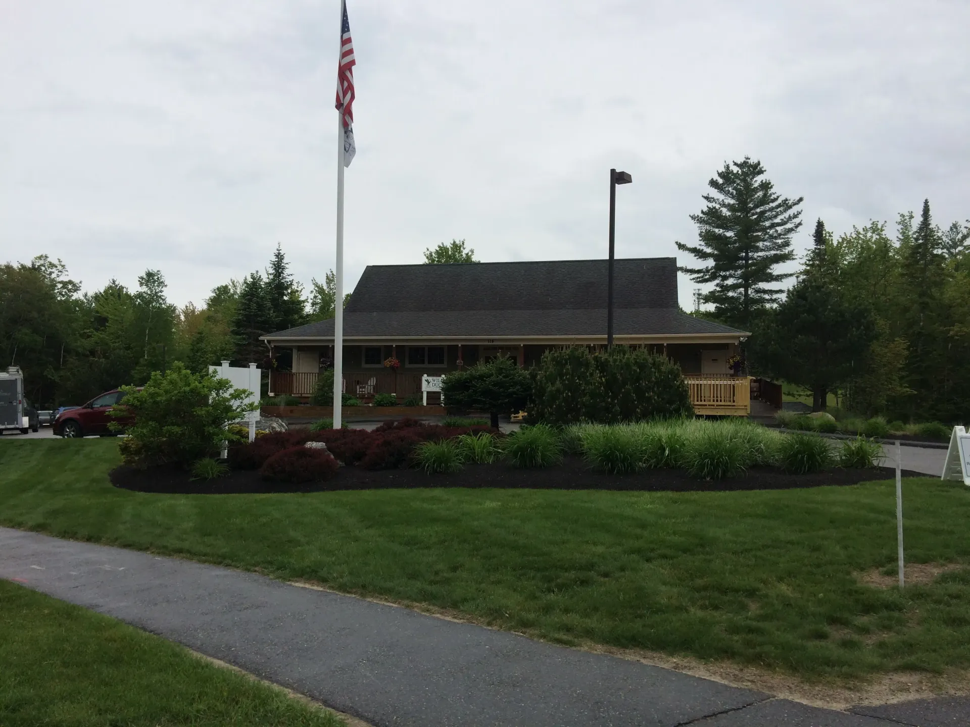 An american flag is flying in front of a house