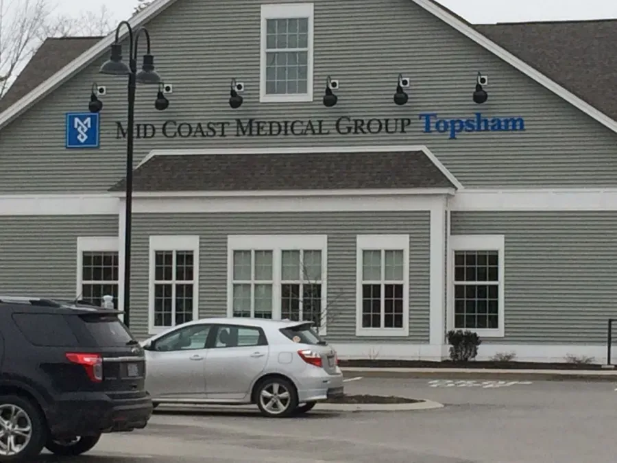Cars are parked in front of a building that says mid coast medical group topsham