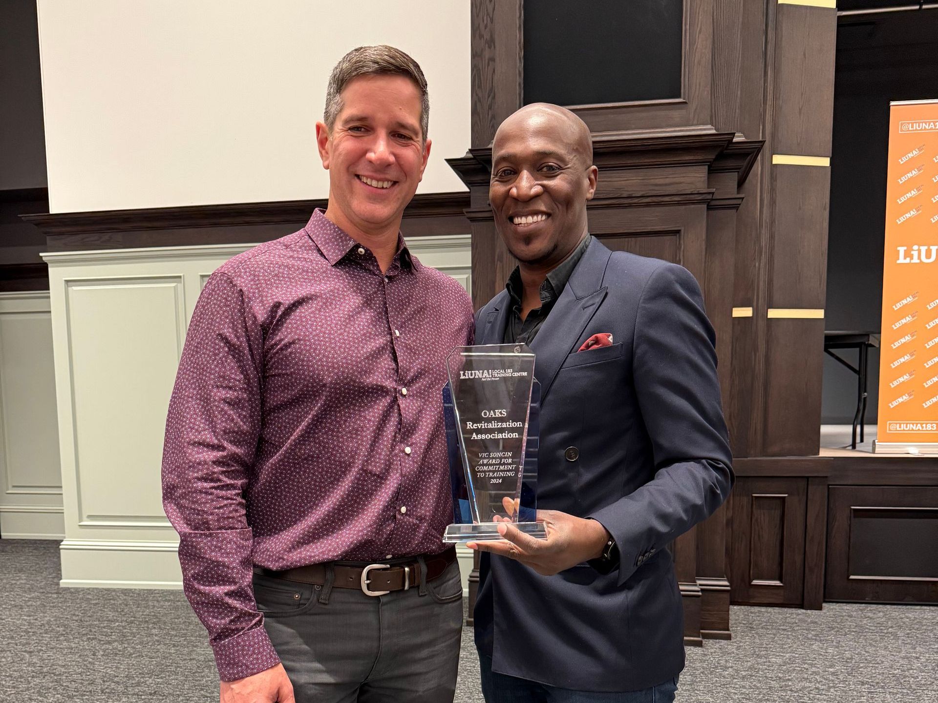 Mark and Joe standing next to each other holding the Vic Soncin Employer Appreciation Award.