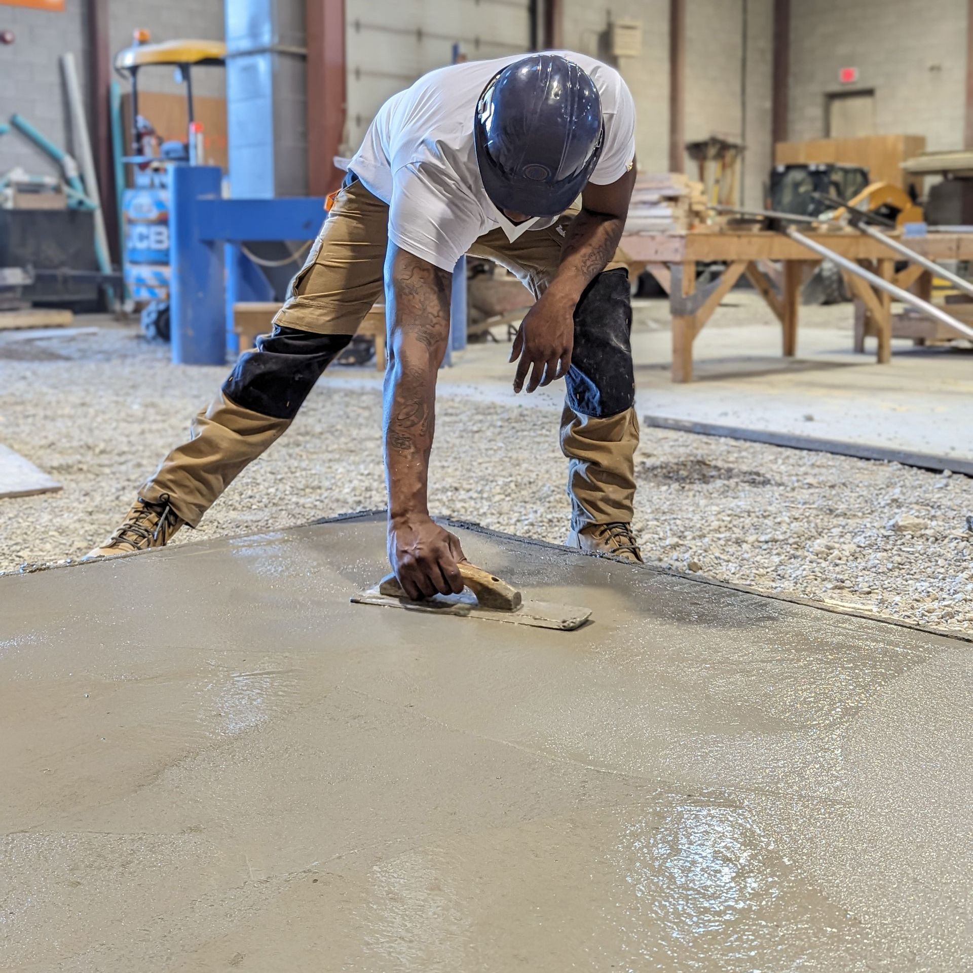 a man is working on a concrete floor