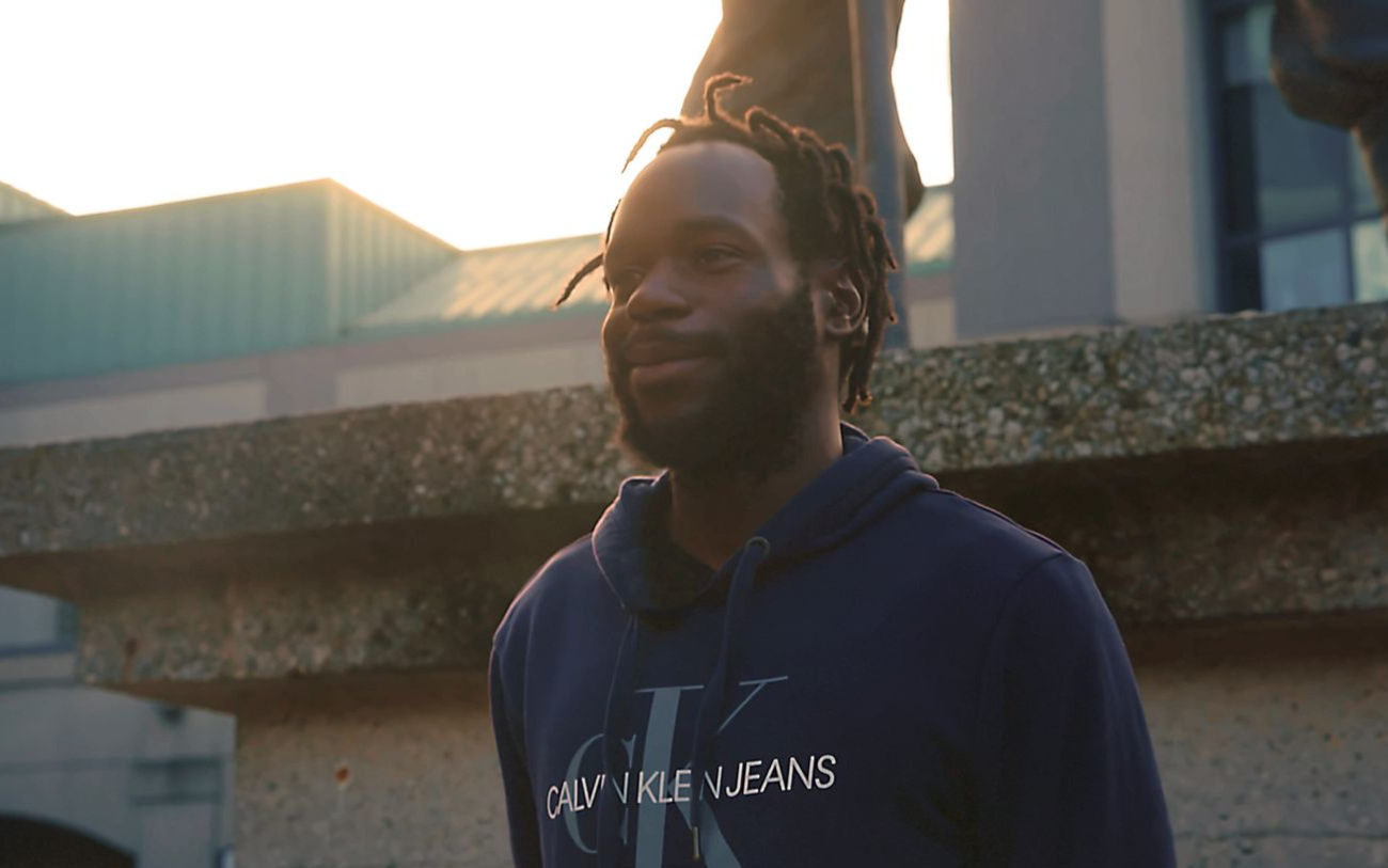 A man is using a circular saw to cut a piece of wood.