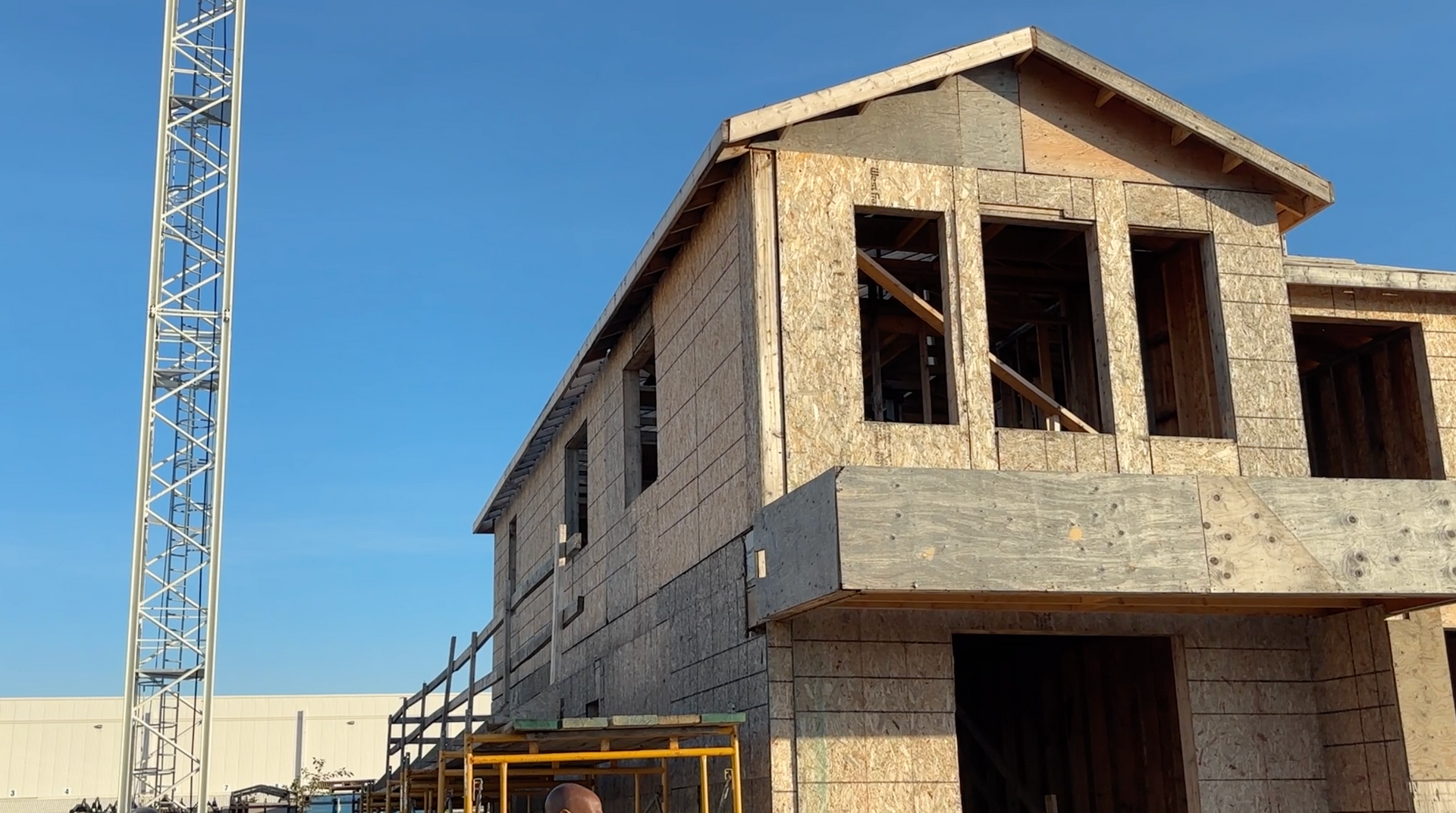 A house is being built with a crane in the background.