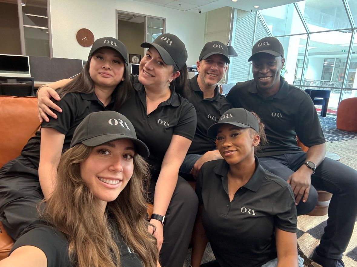 A group of people wearing hats are posing for a picture.