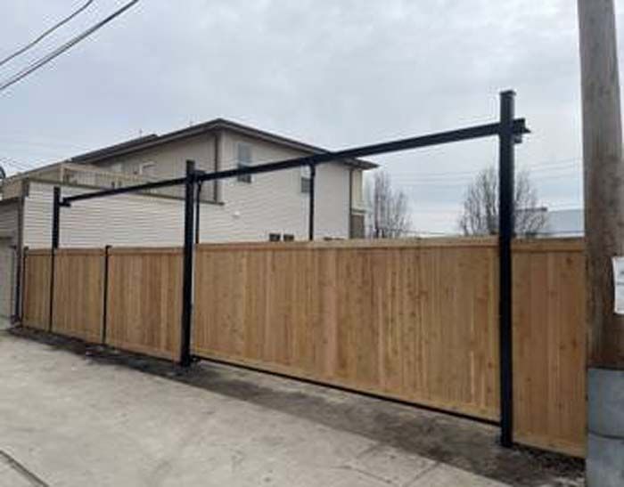 A wooden fence is being built in front of a house.