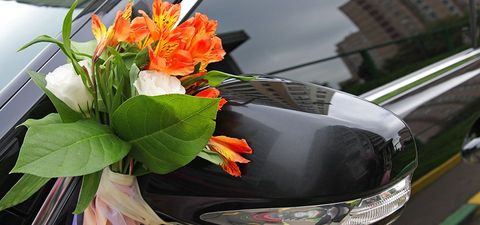 Orange and white flowers on a black limousine