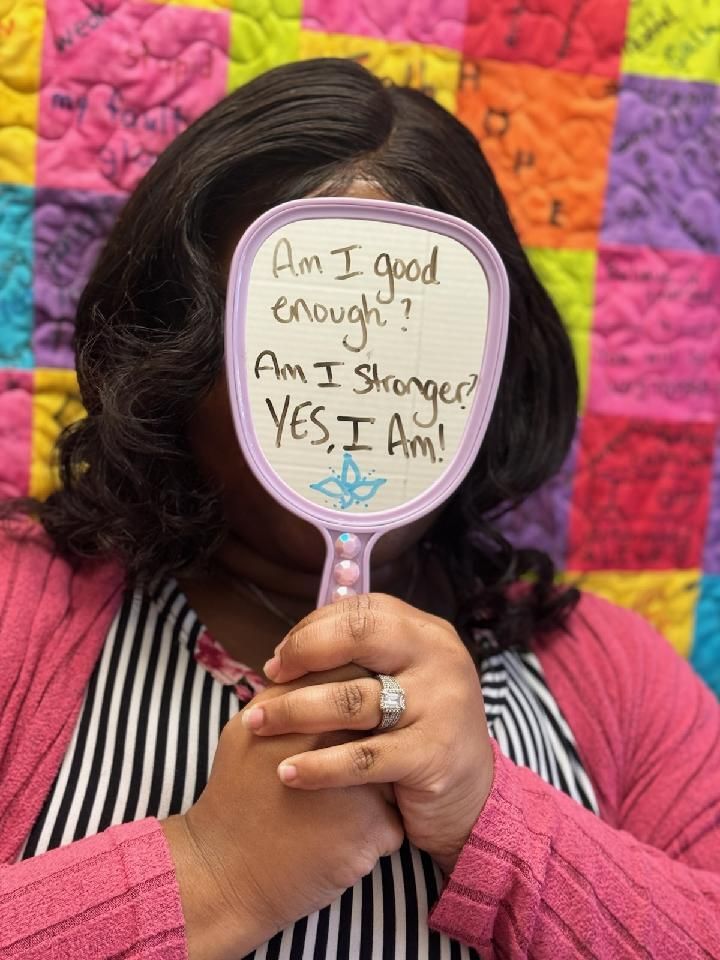 Woman holding a mirror that reflects