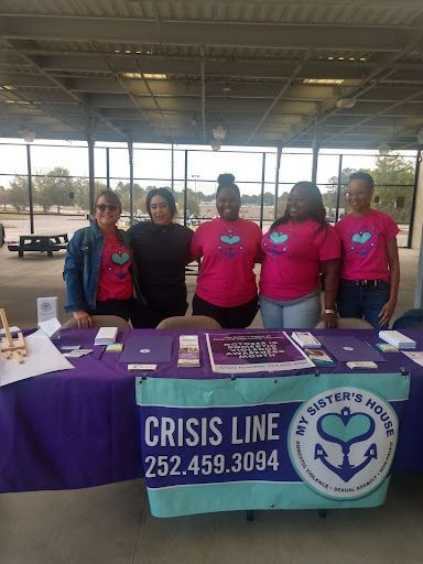 Five women at a table with a