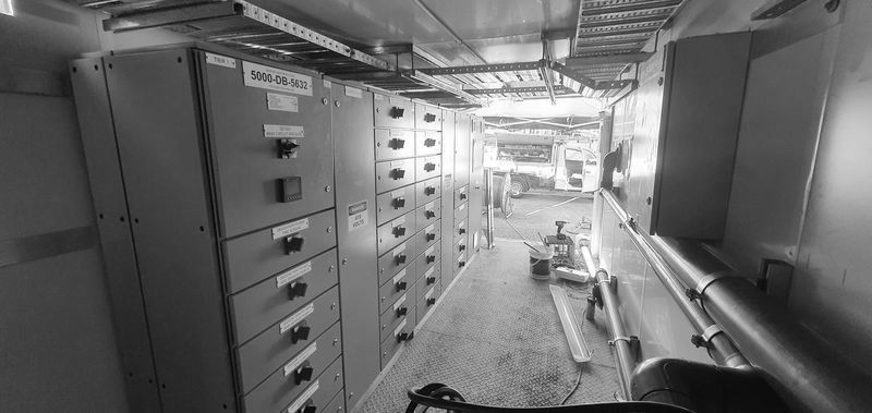 Row of Orange Cabinets Are Lined Up in a Room — Proserpine Electrical Services in Proserpine, QLD