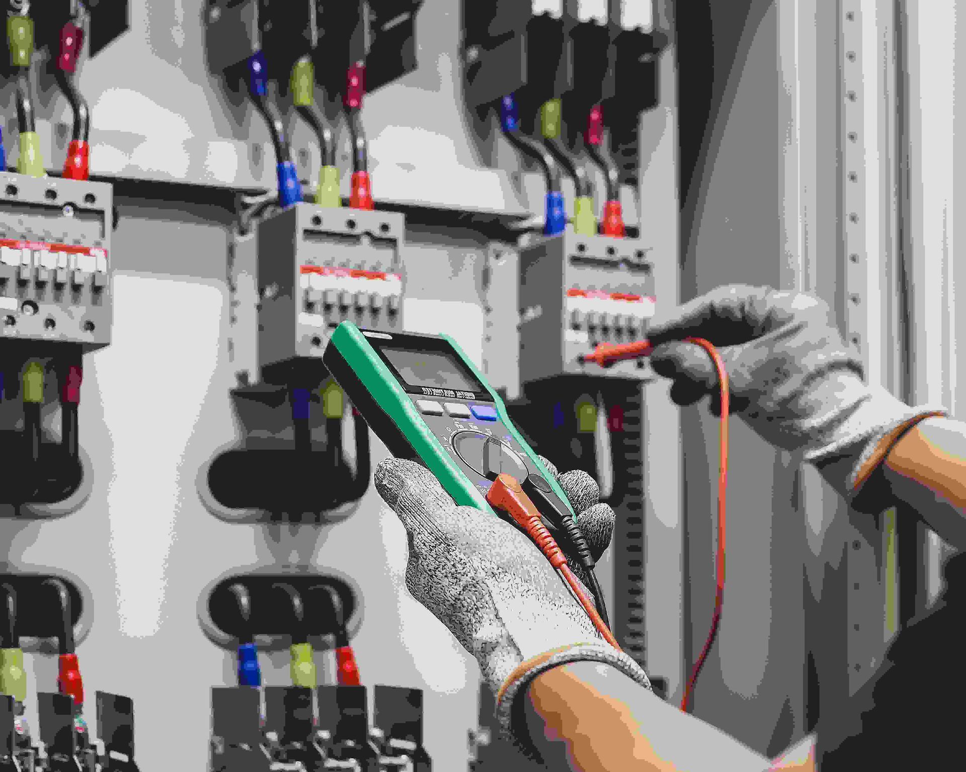 Electrician is Using a Multimeter to Test a Circuit Board — Proserpine Electrical Services in Cannonvale, QLD