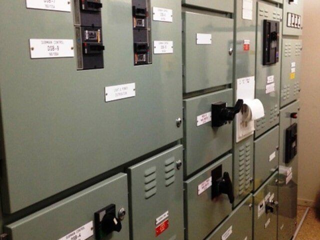 Row of Green Electrical Boxes With Labels on Them — Proserpine Electrical Services in Airlie Beach, QLD