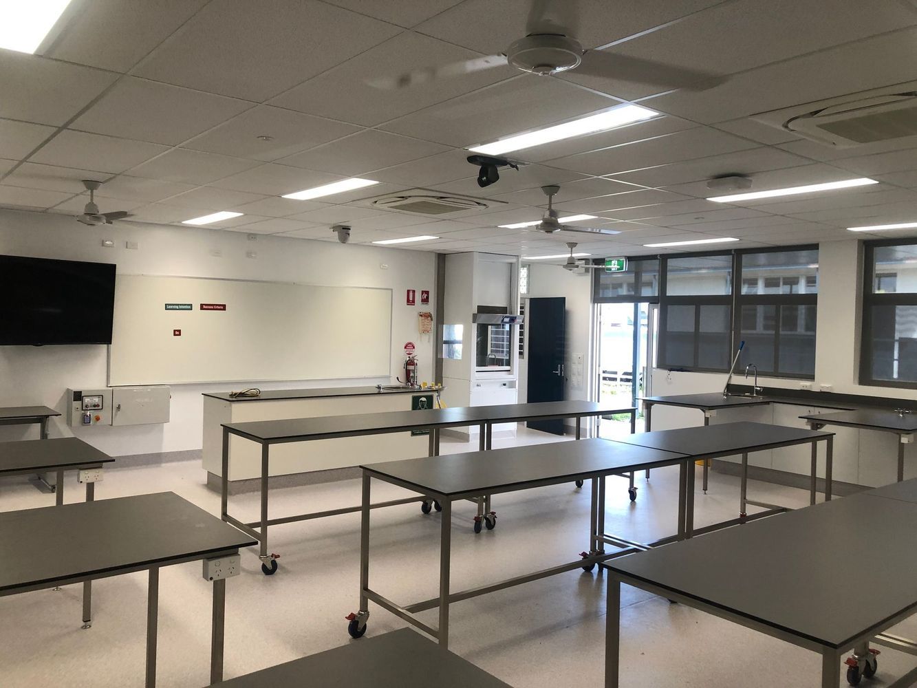 Classroom With a Lot of Tables and a Whiteboard — Proserpine Electrical Services in Proserpine, QLD
