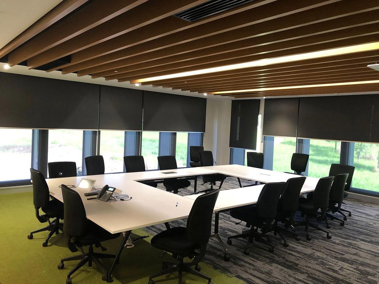 A Conference Room with A Long Table and Chairs — Proserpine Electrical Services in Whitsundays, QLD