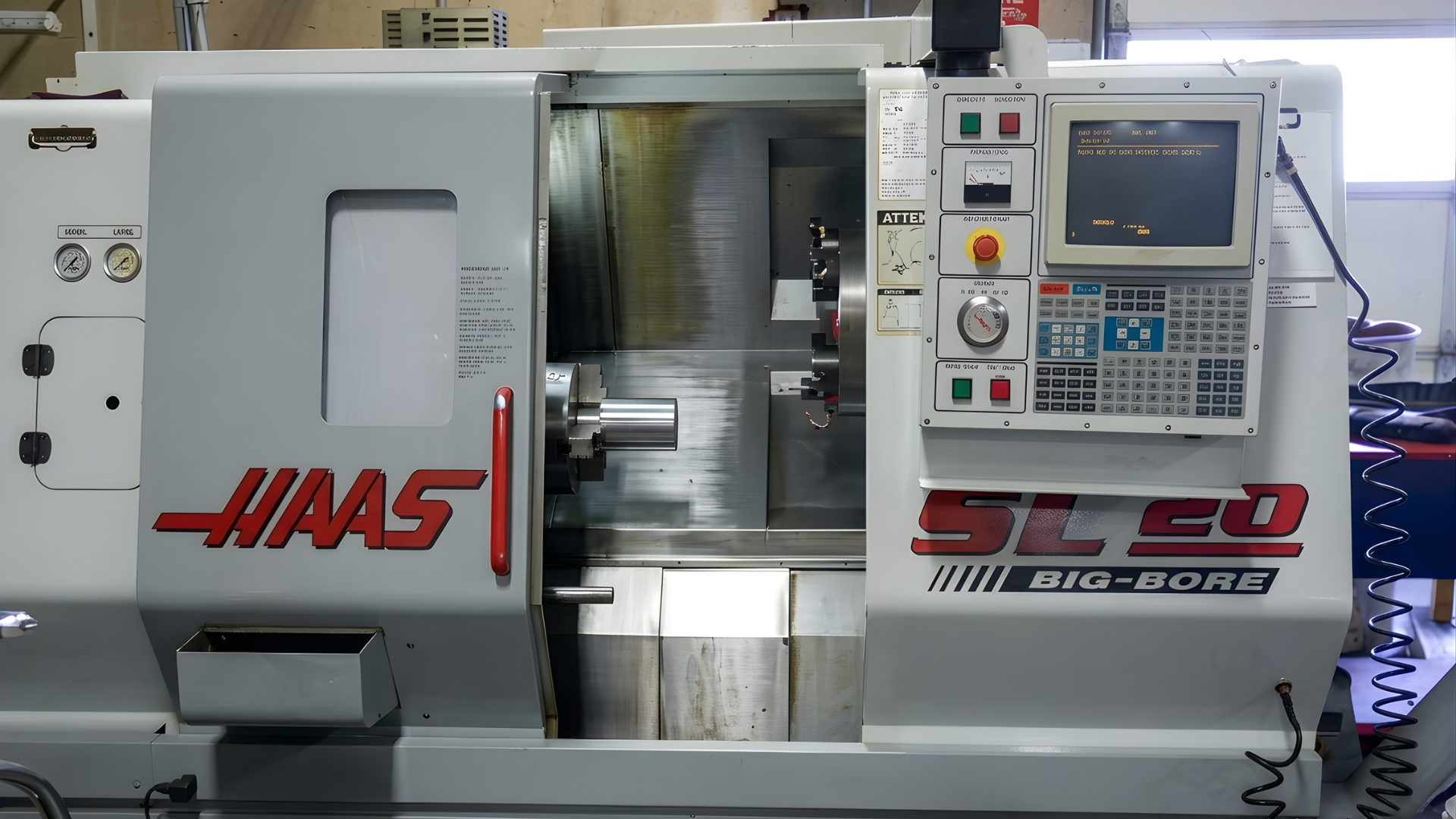 HAAS ST-20 CNC lathe with control panel and enclosed work area in a workshop