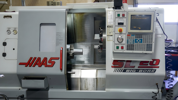 Front view of a Haas ST-20 CNC lathe with control panel and open machine chamber