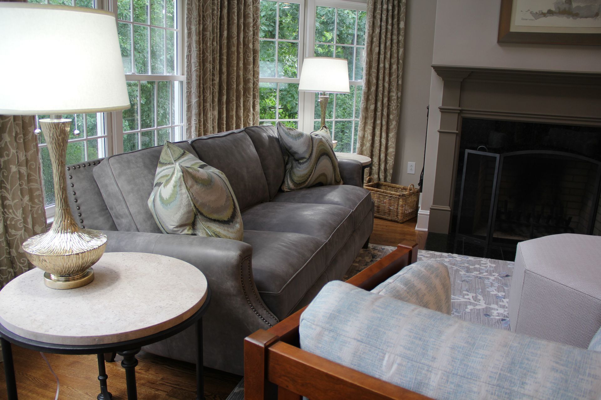 Living room with gray sofa, fireplace, and windows.