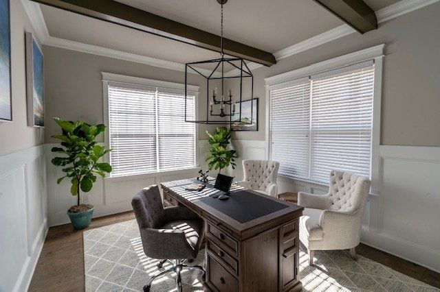 Home office with desk, chairs, and plants by windows, beige and gray.