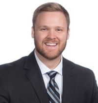 A woman with gray hair is smiling for the camera.