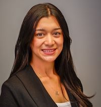 A woman with gray hair is smiling for the camera.