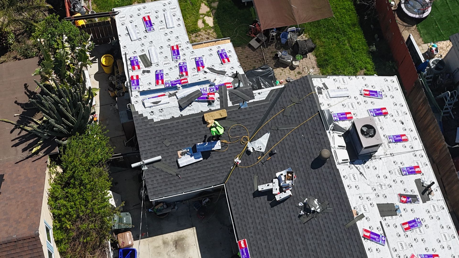 New home under construction with beige brick and grey roof.
