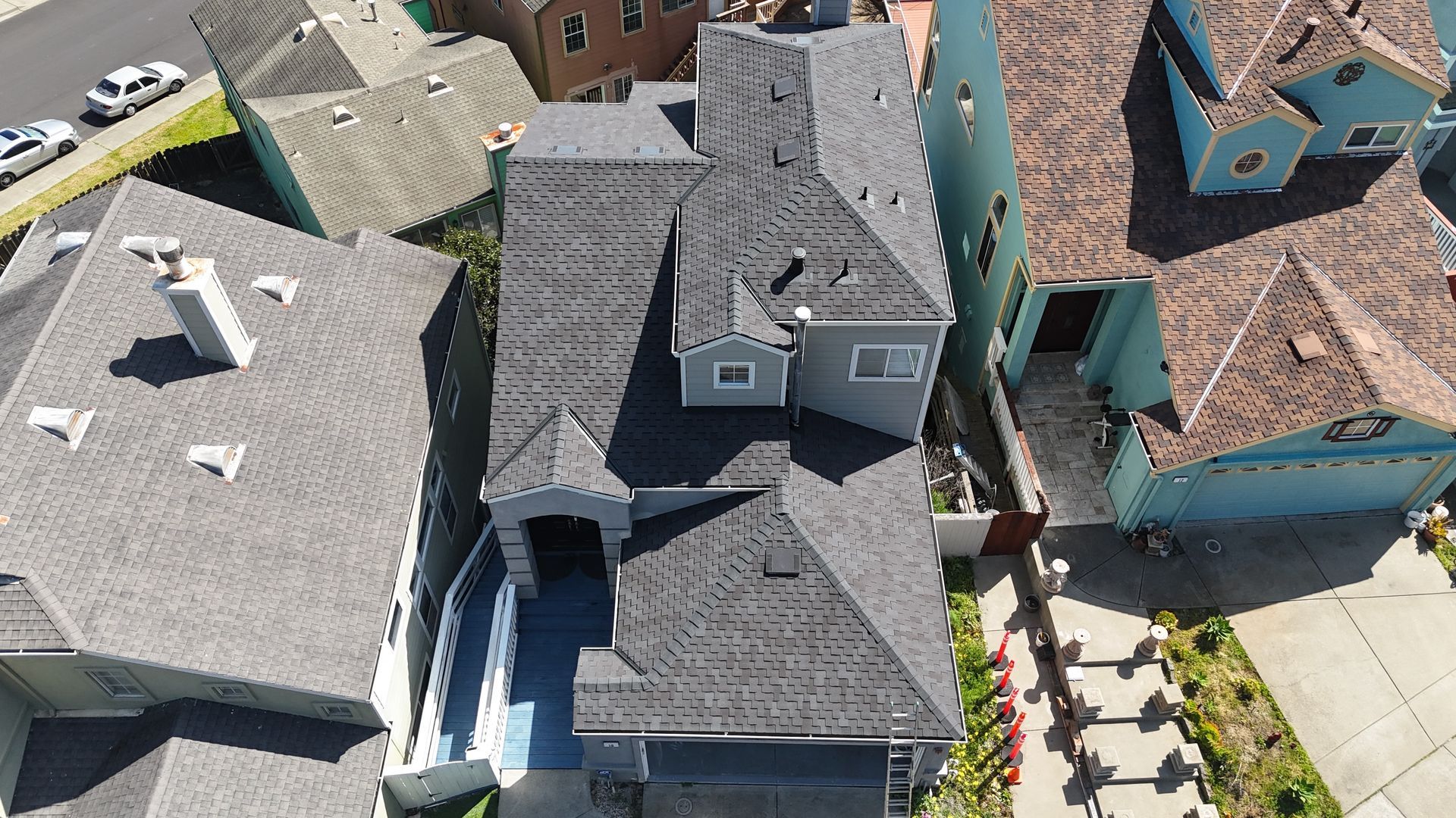 Aerial view of houses with dark gray roofs.