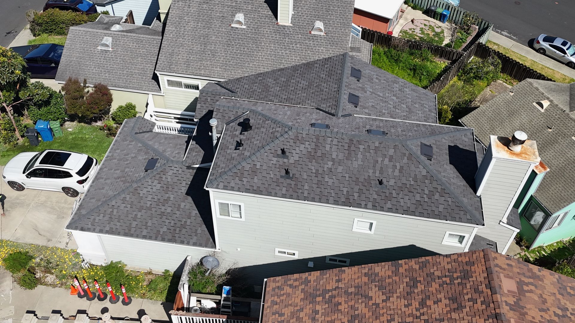 Overhead view of several houses with gray roofs.