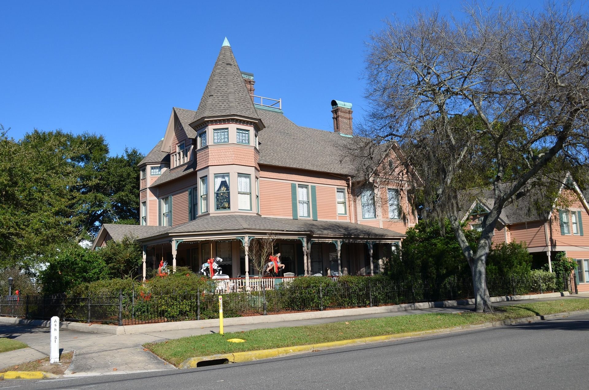 Victorian house with a turret, a wraparound porch.