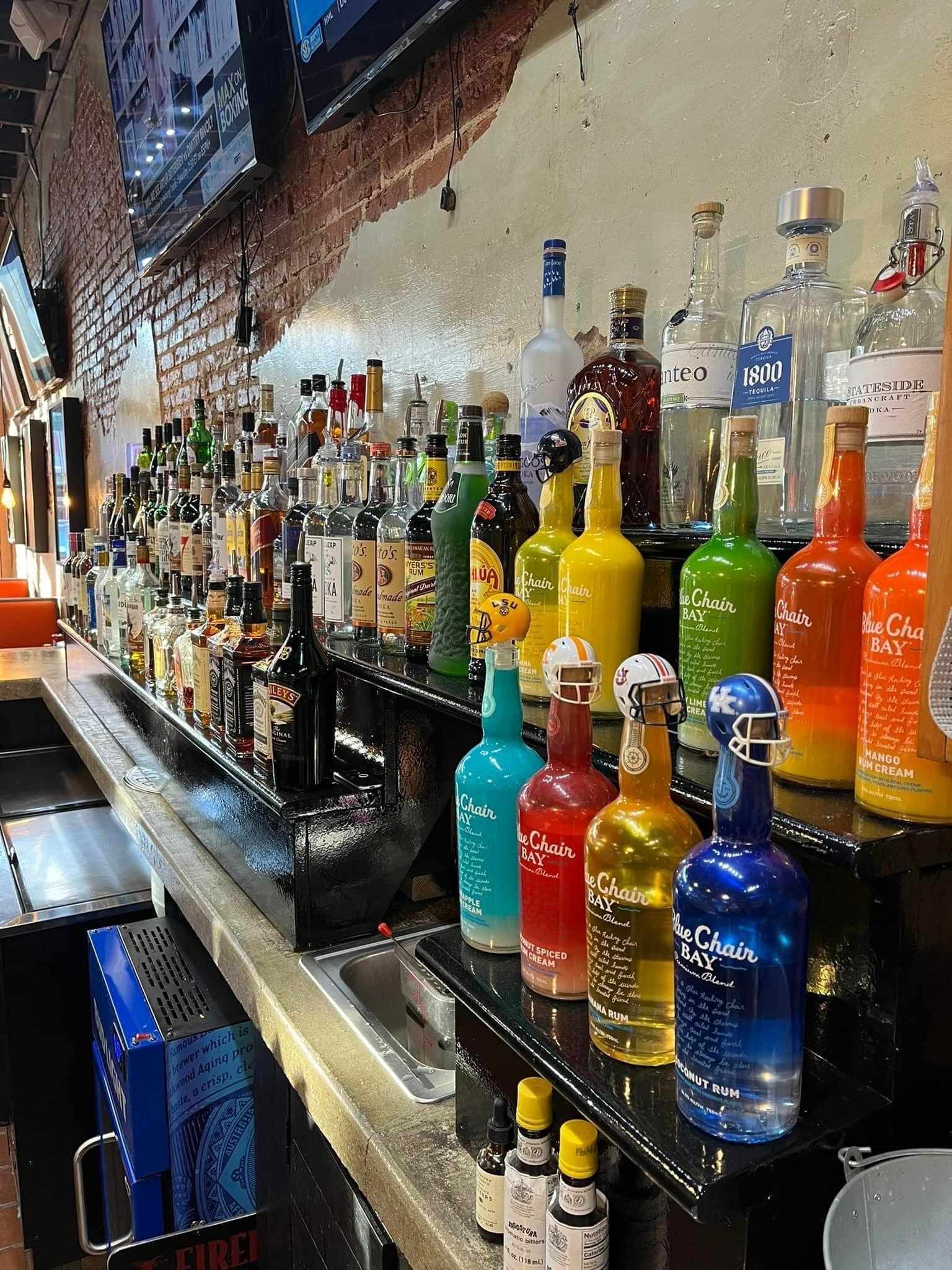 Bar with colorful liquor bottles lined up on shelves.