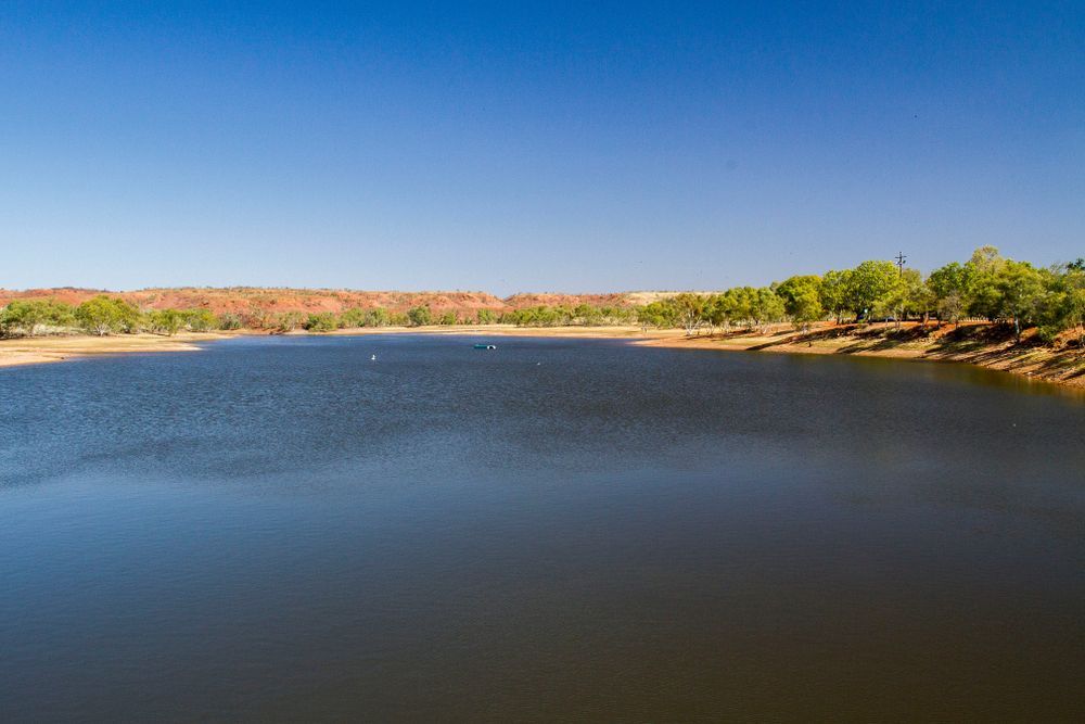 A Large Body Of Water Surrounded By Trees On A Sunny Day — PK Crash Repairs In Tennant Creek, NT