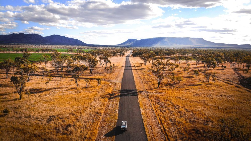 An Aerial View Of A Car Driving Down A Road In The Desert — PK Crash Repairs In Uluru, NT