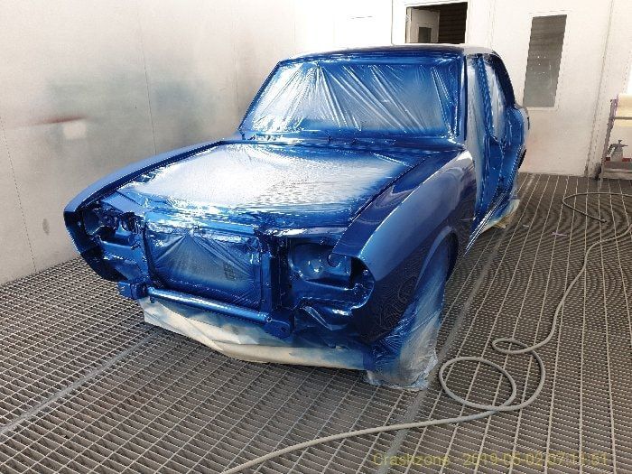 A Blue Car Is Painted In A Paint Booth — PK Crash Repairs In Ciccone, NT