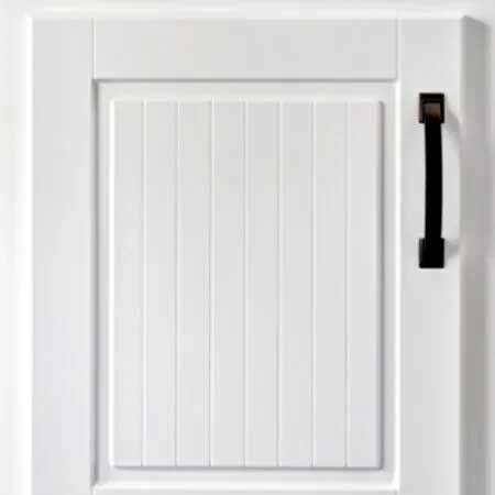 White cabinet door with vertical paneling and black handle.