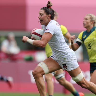 Athletic woman playing rugby