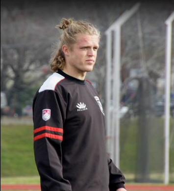 Young rugby player looks on