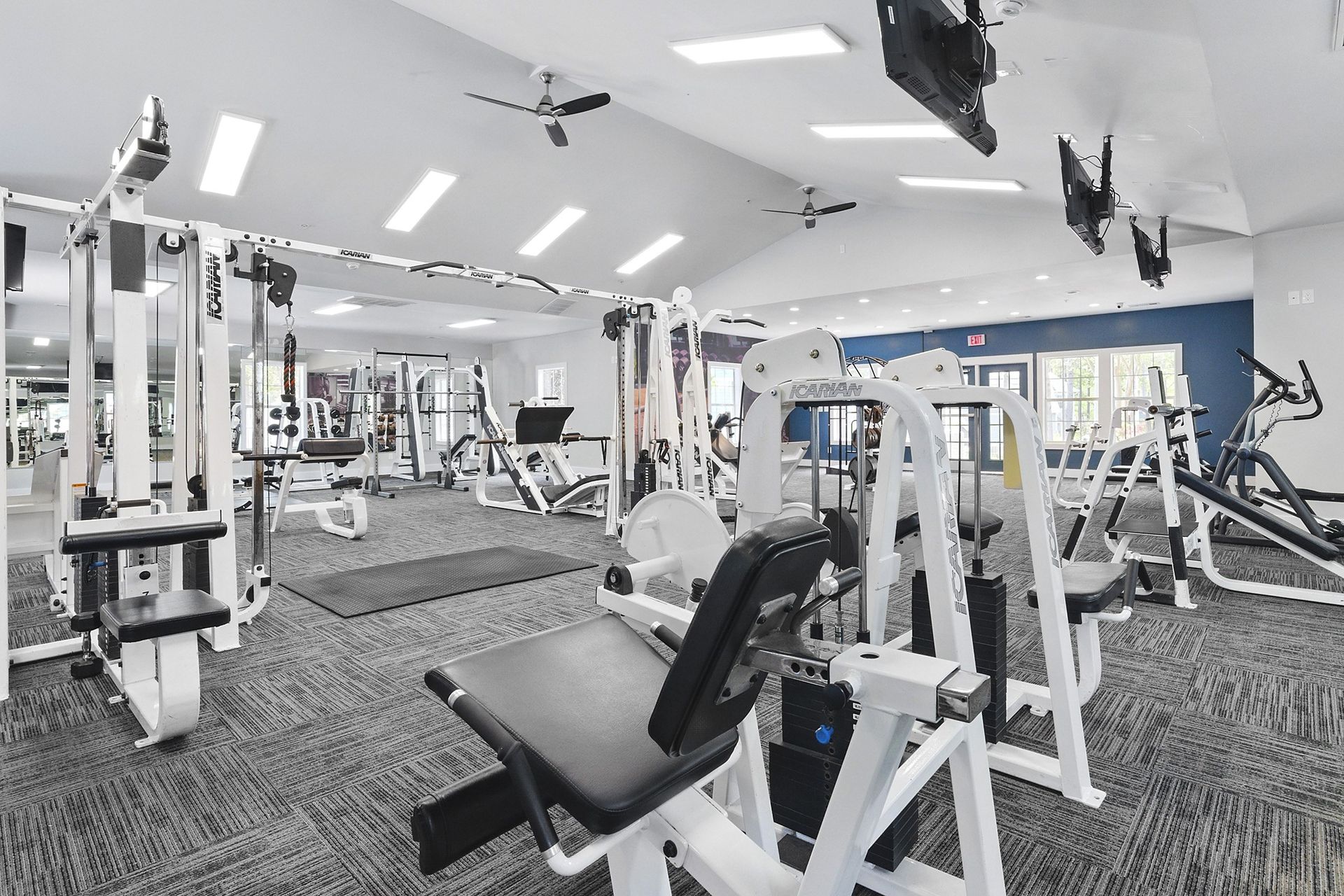 A gym with a variety of equipment including a leg press machine.
