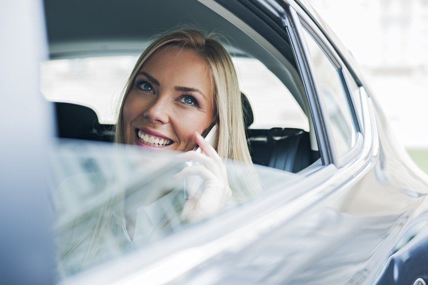 a lady smiling and talking on the phone