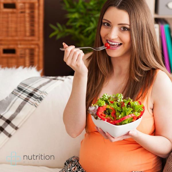 pregnant women eating salad