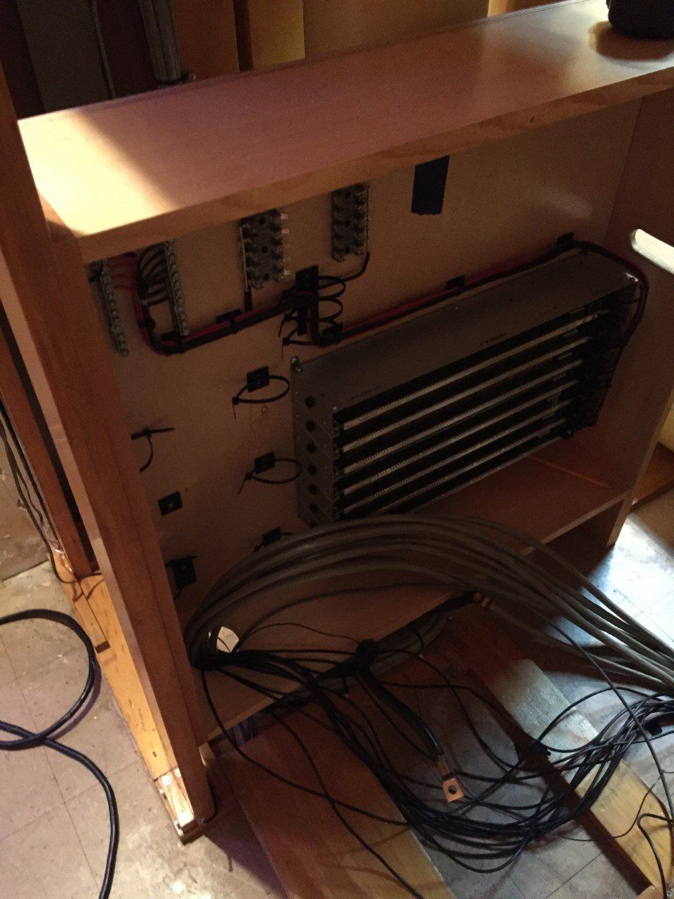 Inside of wooden cabinet, coils and wiring visible.