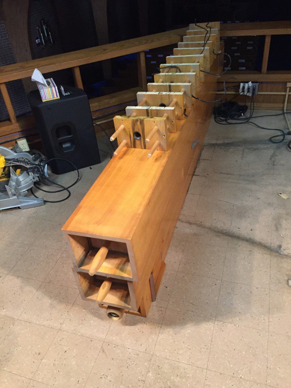 Wooden sound wave experiment instrument with angled dividers, plugs, and electrical components.