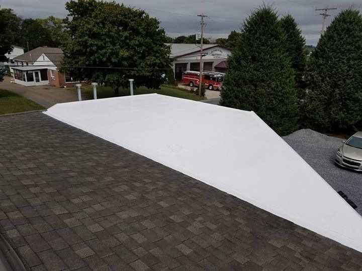 an aerial view of a roof with a white membrane coating