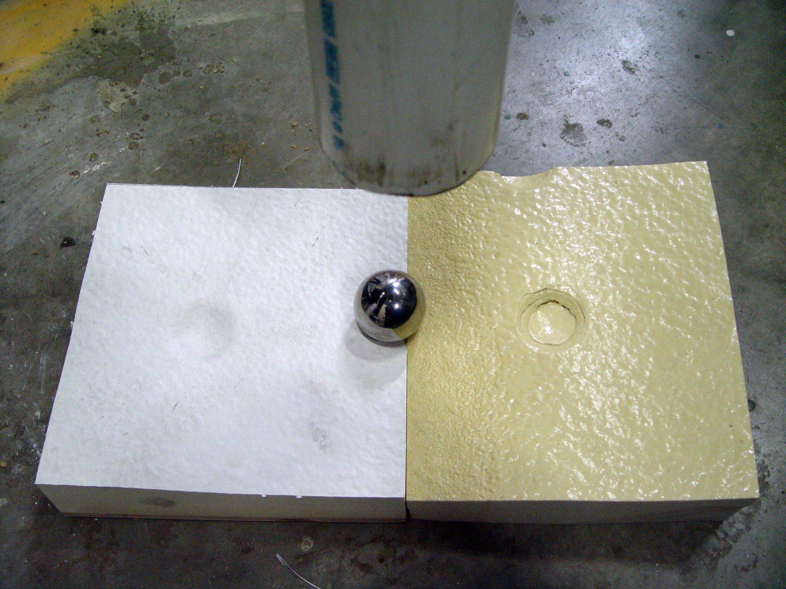 a metal ball placed on a piece of roofing insulation