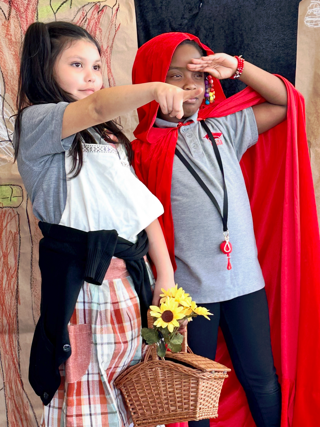 Little red riding hood and little red riding hood standing next to each other