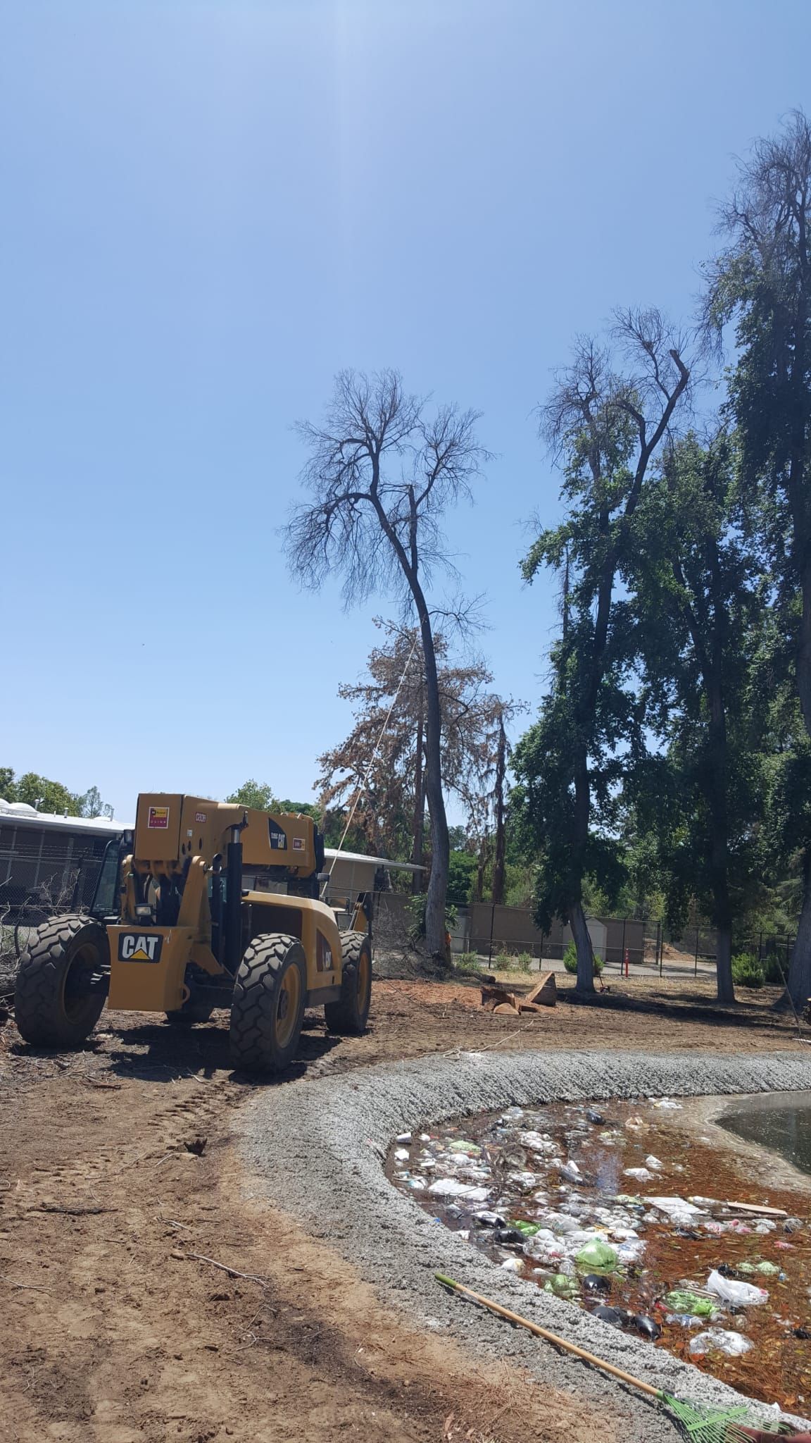 A bulldozer is sitting in the middle of a dirt road.