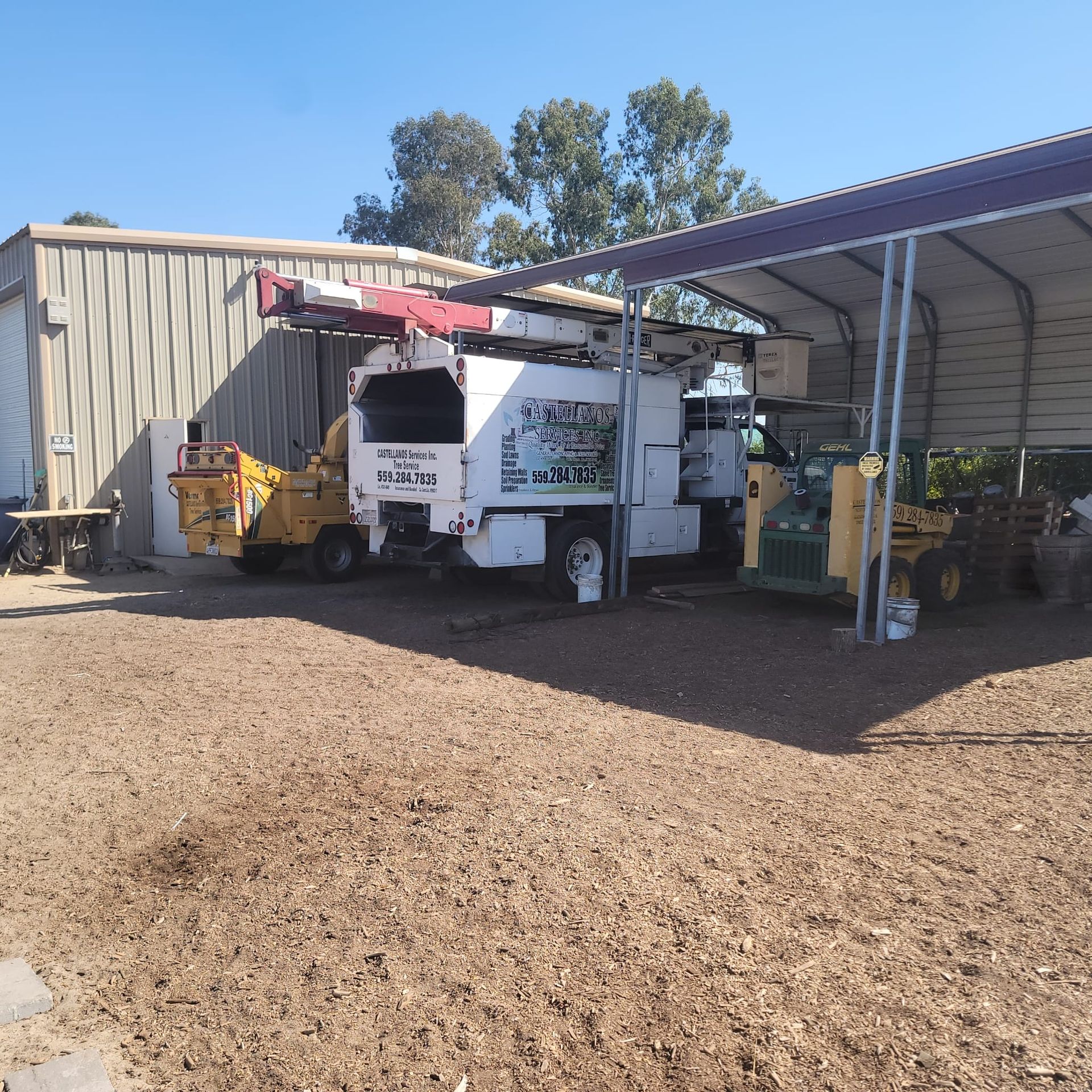 A white truck with a sign on the back that says ' stump grinder '