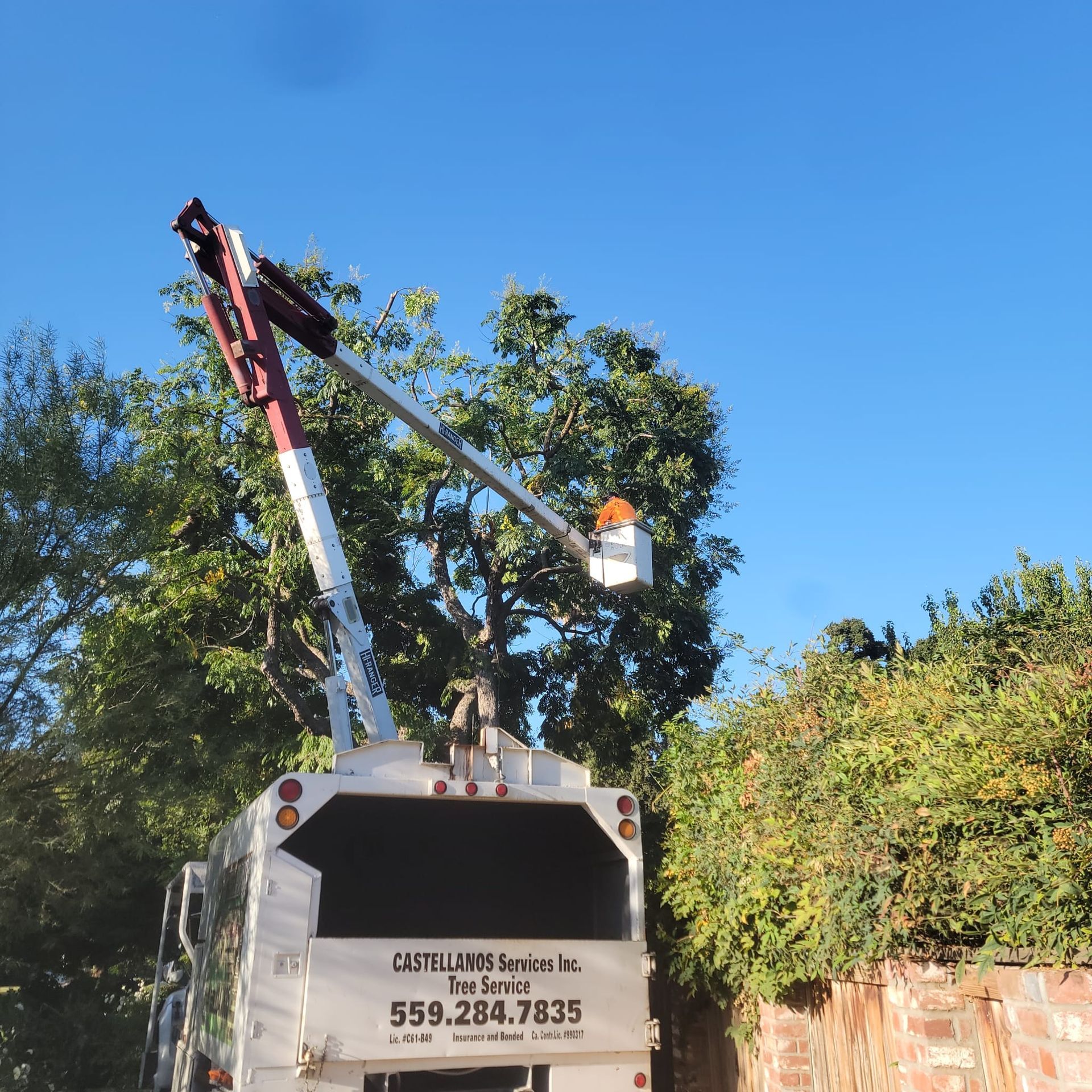 A white truck with a crane on the back of it