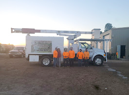 A group of people are standing in front of a truck.